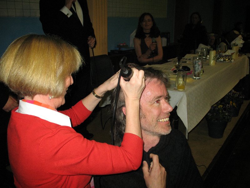 Remember that man in the white shirt? John  Delaney? Well, this is  one of the higher than high points of this high point evening, as money was donated to see John sacrifice a lovely head of hair for the cause. Moira was asked to do the honours!